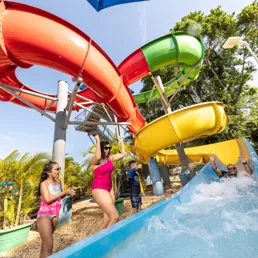 Family enjoys the water slide at the LEGOLAND Hotel pool