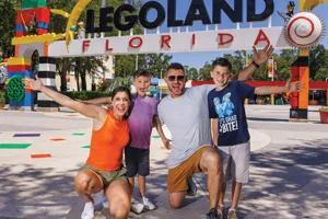 Family of four posing in front of the LEGOLAND Florida cntrance