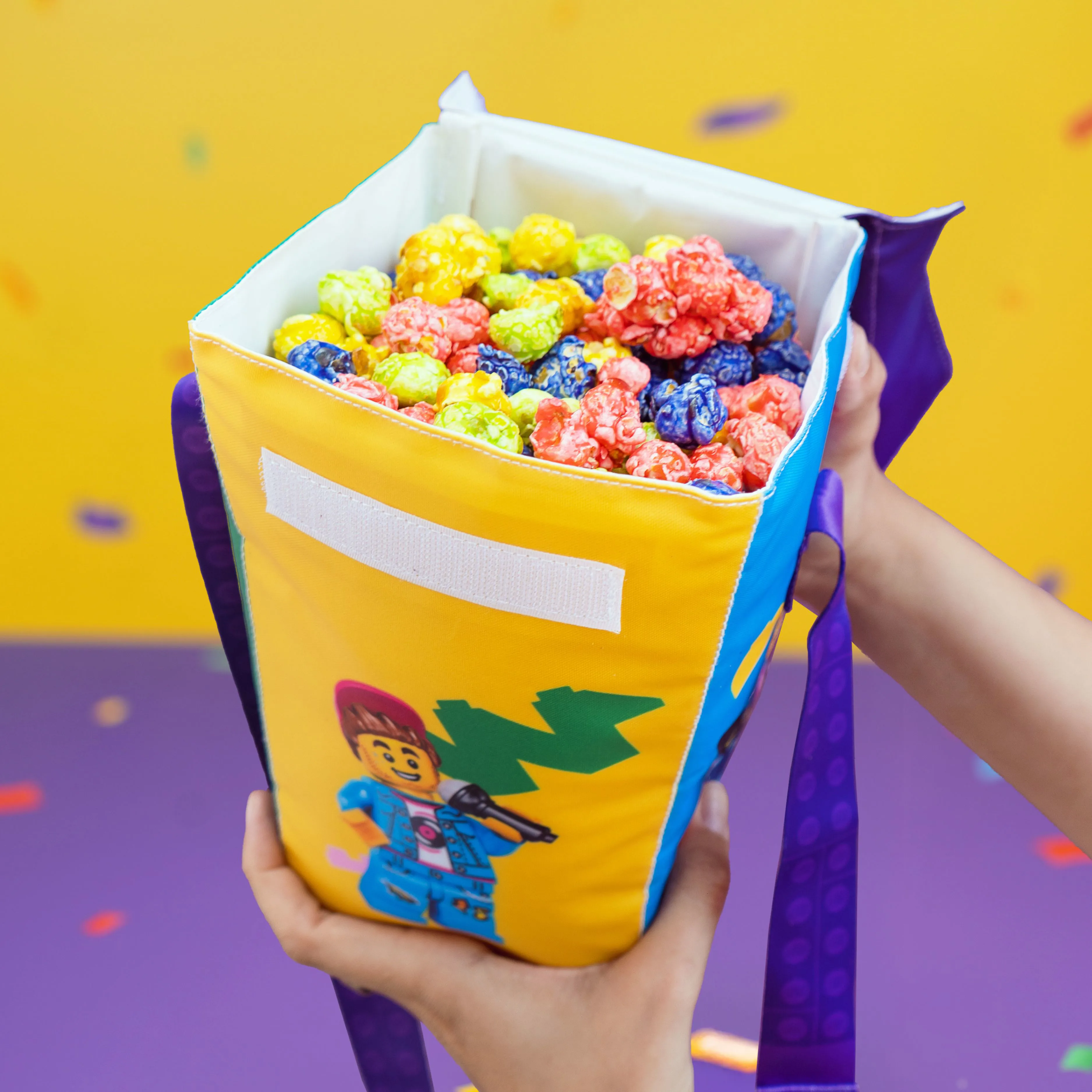 Image of Tutti Frutti flavored popcorn served in a LEGO® Festival souvenir popcorn bucket at LEGOLAND Florida